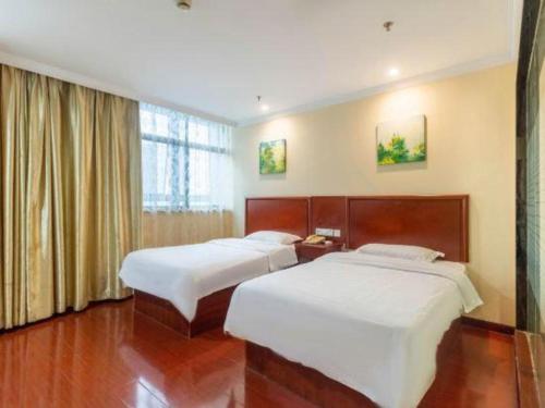 Ένα ή περισσότερα κρεβάτια σε δωμάτιο στο GreenTree Inn Wuhu Fangte Second Phase Nanxiang Wanshang Express Hotel