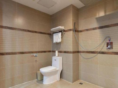 a bathroom with a toilet and a shower at GreenTree Inn Wuhu Fangte Second Phase Nanxiang Wanshang Express Hotel in Wuhu