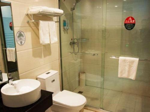 a bathroom with a shower and a toilet and a sink at GreenTree Inn Wuhu Fangte Second Phase Nanxiang Wanshang Express Hotel in Wuhu