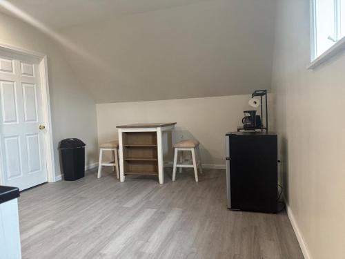 an empty room with a table and chairs and a door at Downtown Golden Stairs in Buffalo