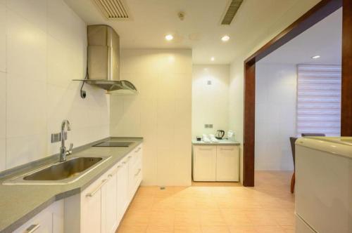a kitchen with a sink and a counter top at Xiamen Fortune Hotel in Xiamen
