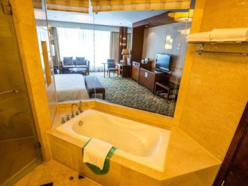 a bathroom with a tub in a hotel room at Xiamen Fortune Hotel in Xiamen