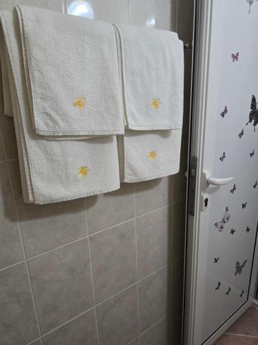 a bathroom with white towels and a shower at Stephanovy Guest House in Sozopol