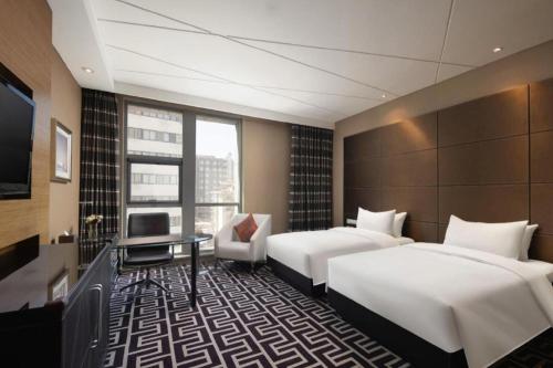 Ένα ή περισσότερα κρεβάτια σε δωμάτιο στο Brigh Radiance Hotel Yantai