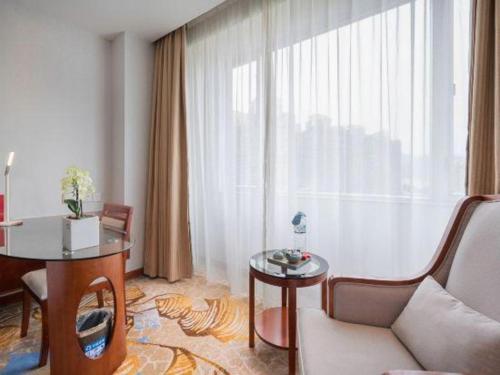 a living room with a couch and a table at Xiamen Airlines Quanzhou Hotel in Quanzhou