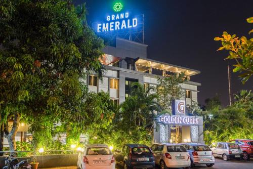 a hotel with cars parked in front of it at Treebo Tryst Grand Emerald in Pune