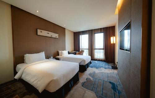 Postel nebo postele na pokoji v ubytování Geno Hotel Shah Alam