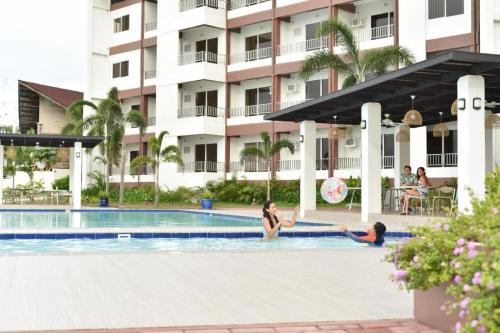 a group of people in the swimming pool at a hotel at Holiday Oceanview Residences and Resort in Davao City