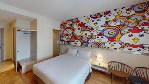a bedroom with a white bed and a painting on the wall at Nite and Day Batam Jodoh Square in Nagoya