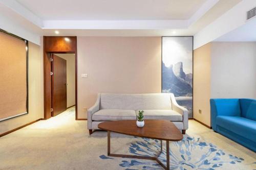 a living room with a couch and a table at Guilin Manhatton Hotel Tianjie in Guilin