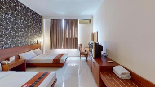 Postel nebo postele na pokoji v ubytování Hotel Bintang