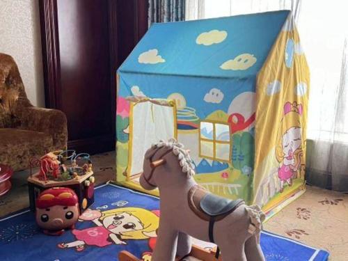 a toy horse in front of a play tent at King Century Hotel in Zhongshan