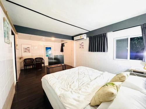 a bedroom with a large white bed in a room at Near beach hostel in Bang Tao Beach