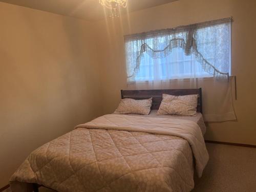 a bedroom with a large bed with a window at STR25-15 Private Room in Marina