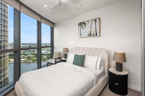 a bedroom with a bed and a large window at New Luxe 2BR Queens Wharf Apt in Brisbane