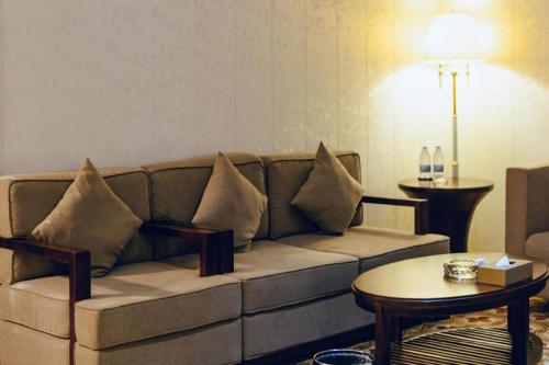 a living room with a couch and a table at Manhatton Hotel Beihai in Beihai