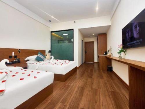 a hotel room with two beds with hearts on them at Lijiang Liwang Hotel in Lijiang