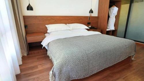 a bedroom with a large bed with a wooden floor at Lijiang Liwang Hotel in Lijiang