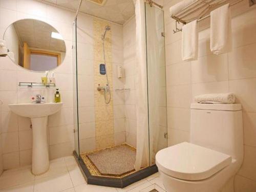 a bathroom with a shower and a toilet and a sink at Anyi 158 Hotel Fuqin in Chengdu