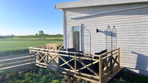 a house with a wooden deck on the side of it at Villa Vinja in Ystad