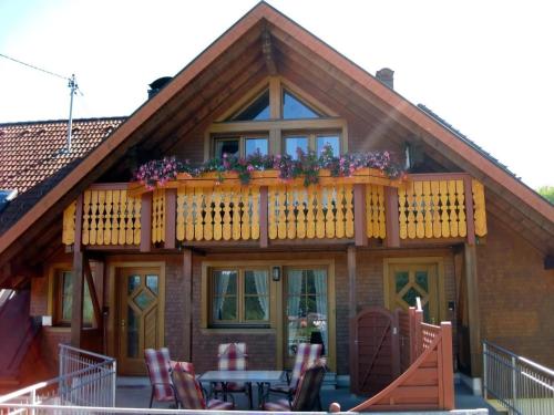 a house with a balcony with flowers on it at Appartement In Wittenschwand in Wittenschwand