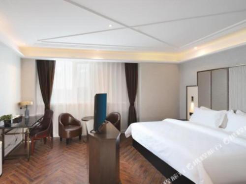 Postel nebo postele na pokoji v ubytování Jinjiang Metropolo Hotel Nanjing Jiangning Binjiang Development Zone