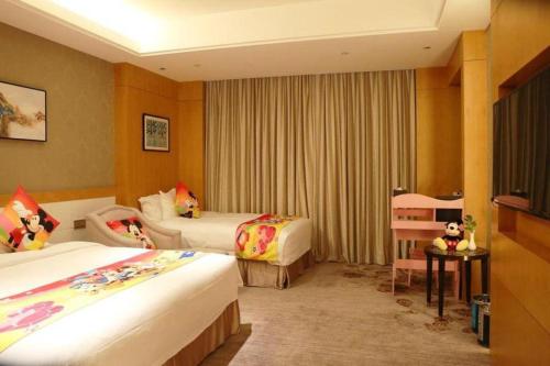a hotel room with two beds and a chair at Weida Hotel Jinhua in Jinhua