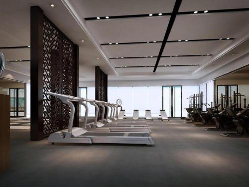 a large room with rows of exercise bikes and chairs at Weida Hotel Jinhua in Jinhua