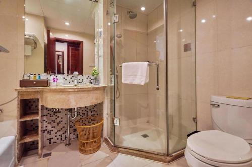 a bathroom with a shower and a toilet and a sink at Huangshan International Hotel in Huangshan