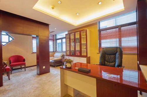 an office with a desk with a chair and a couch at Huangshan International Hotel in Huangshan