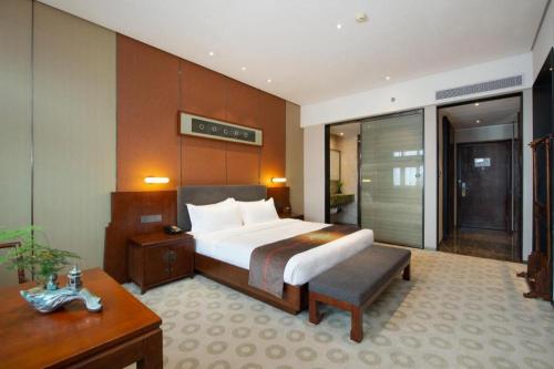 Postel nebo postele na pokoji v ubytování Rezen Hotel Pasonda Junyu