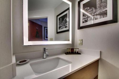 a bathroom with a white sink and a mirror at Best Western Plus Boston Hotel in Boston