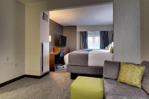 a hotel room with a bed and a couch at Best Western Plus Boston Hotel in Boston