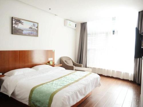 a bedroom with a large bed and a window at Vatica Shanghai Jiading District Anting Metro Station Moyu Road Hotel in Shanghai