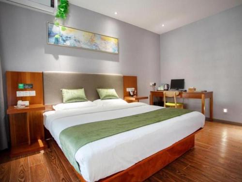 a bedroom with a large bed in a room at Vatica Shanghai Jiading District Anting Metro Station Moyu Road Hotel in Shanghai