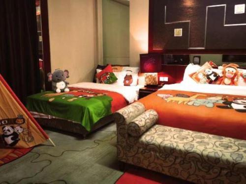 a bedroom with two beds with stuffed animals on them at Dunhuang Grand Soluxe Hotel in Dunhuang