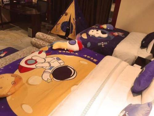 a bedroom with a bed with a surfboard on it at Dunhuang Grand Soluxe Hotel in Dunhuang
