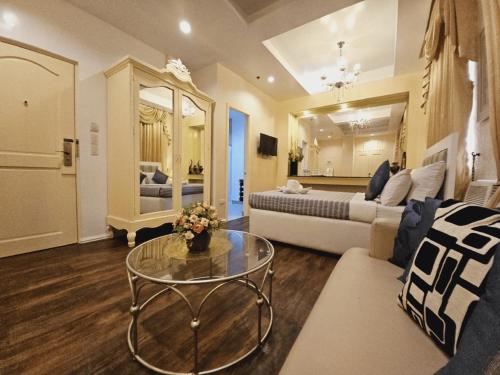 a living room with a couch and a table at Islands Hotel in Roxas City