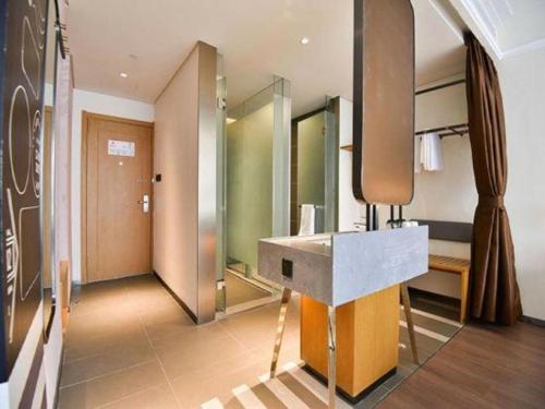 a bathroom with a sink and a mirror at ibis xian North Second Ring Weiyang Rd Hotel in Xi'an