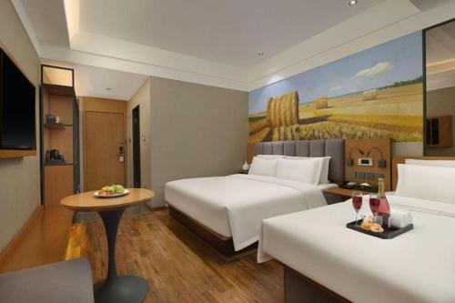 Télévision ou salle de divertissement dans l'établissement Qiuguo Hotel Beijing BIEC & Airport