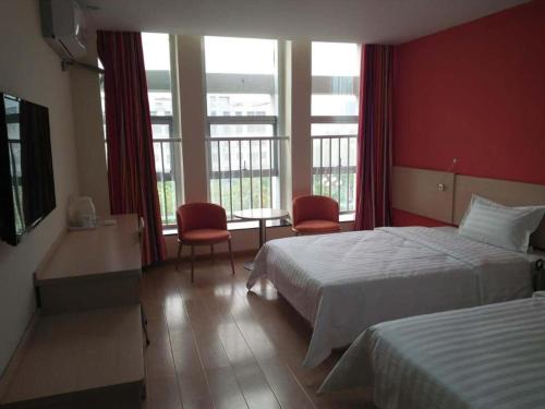 Ένα ή περισσότερα κρεβάτια σε δωμάτιο στο 7 Days Inn Tai'an Feicheng Longshan Road