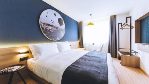 a bedroom with a large bed and a window at Ibis Styles Shanghai Qingpu Sports Center Hotel in Shanghai