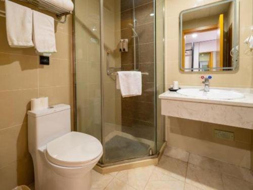 a bathroom with a toilet and a sink and a shower at GreenTree Inn Shanghai Railway Station Macao Road in Shanghai