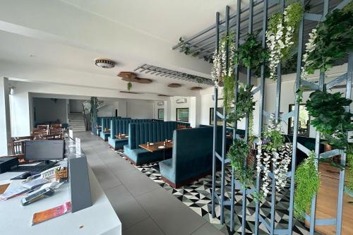 a restaurant with blue chairs and tables and plants at LP Regency in Pune