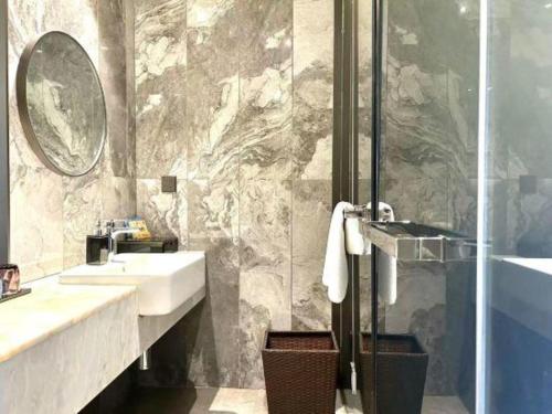 a bathroom with a sink and a shower at Taiyi International Hotel in Wenzhou
