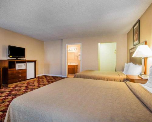 a hotel room with two beds and a television at Quality Inn Redding near I-5 in Redding