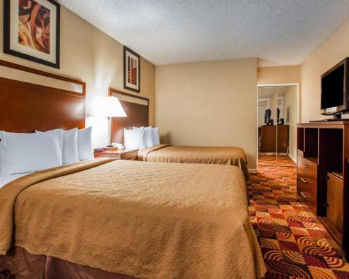 a hotel room with two beds and a television at Quality Inn Redding near I-5 in Redding