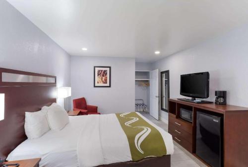 a hotel room with a bed and a television at Quality Inn Redding near I-5 in Redding