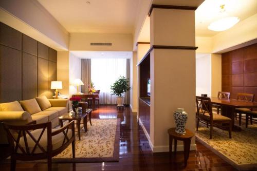 a living room with a couch and a table at Kai Wah Plaza International Hotel in Kunming