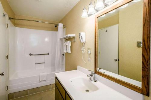 a bathroom with a sink and a mirror at Quality Inn Redding near I-5 in Redding